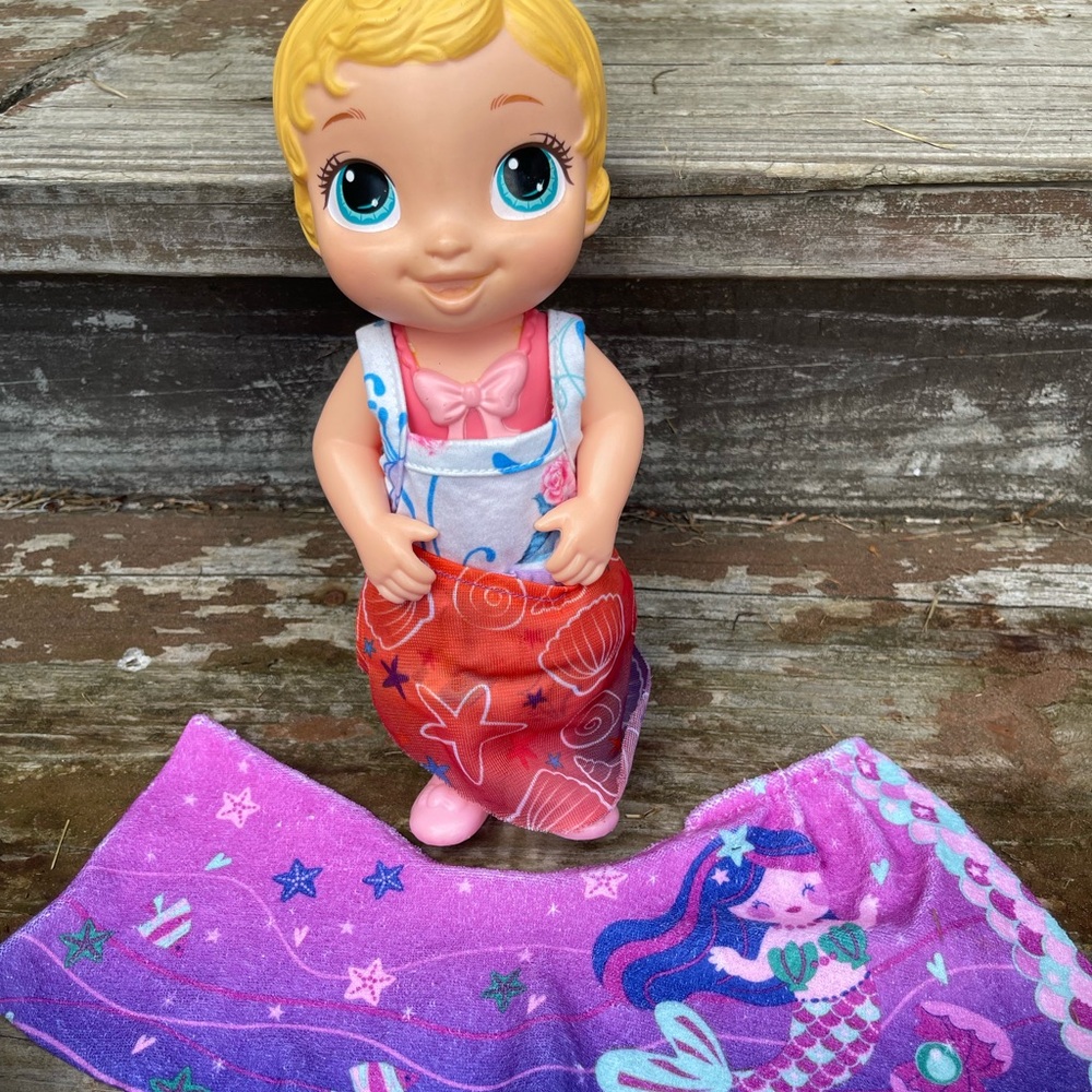 Adorable Baby Doll with Red and Purple Blanket